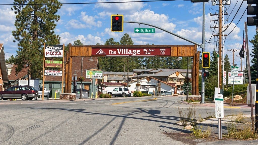 Wooden The Village Big Bear Lake sign over the commercial entrance at Big Bear Blvd and Highway 18