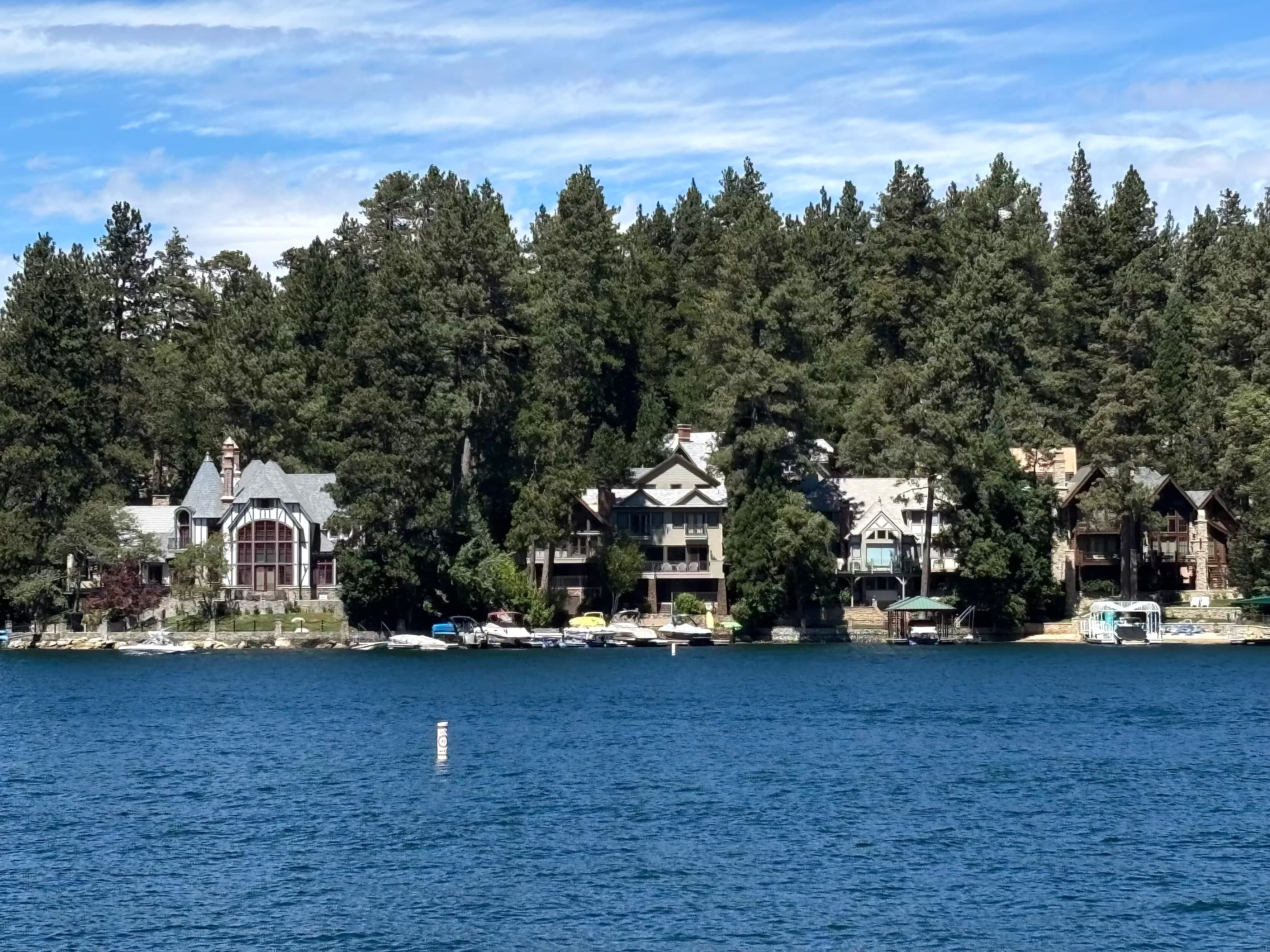 Large waterfront homes and private docks along Lake Arrowhead among pines