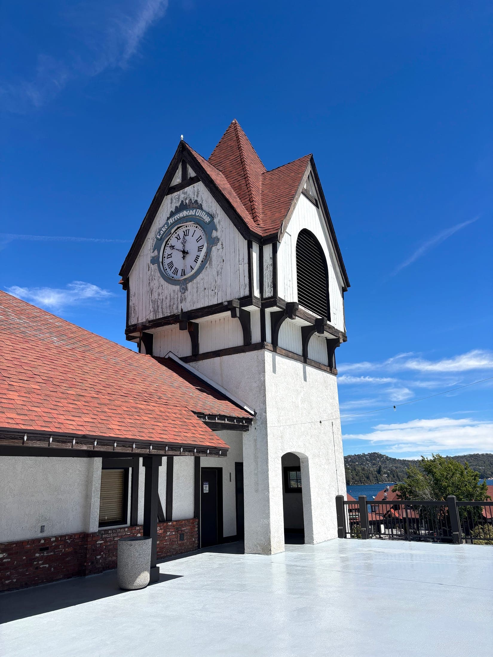 Tudor-style clock tower at Lake Arrowhead Village under a blue sky in California