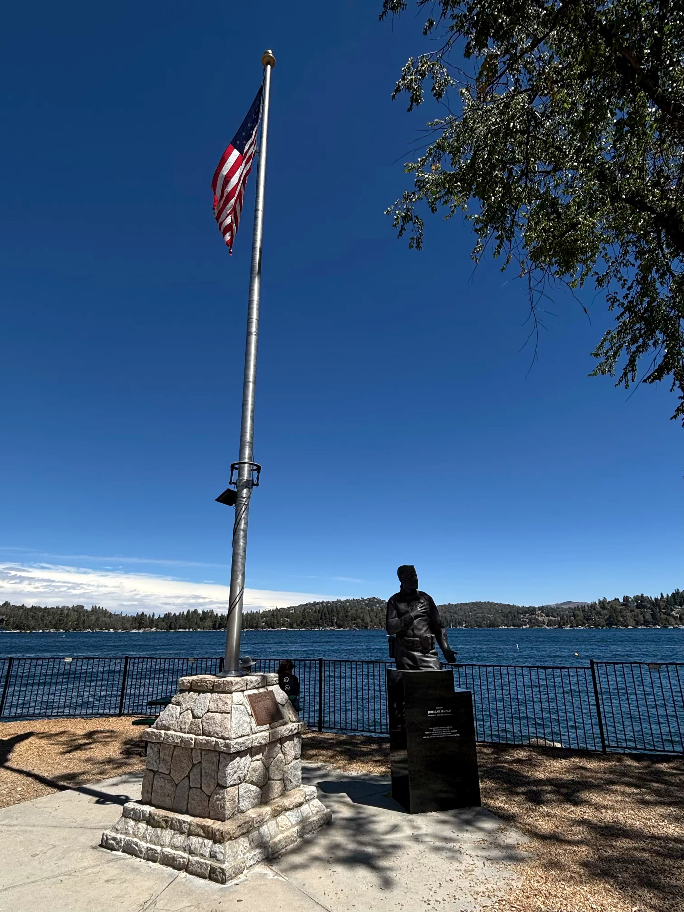 American flag on a stone base overlooking Lake Arrowhead from the Village waterfront