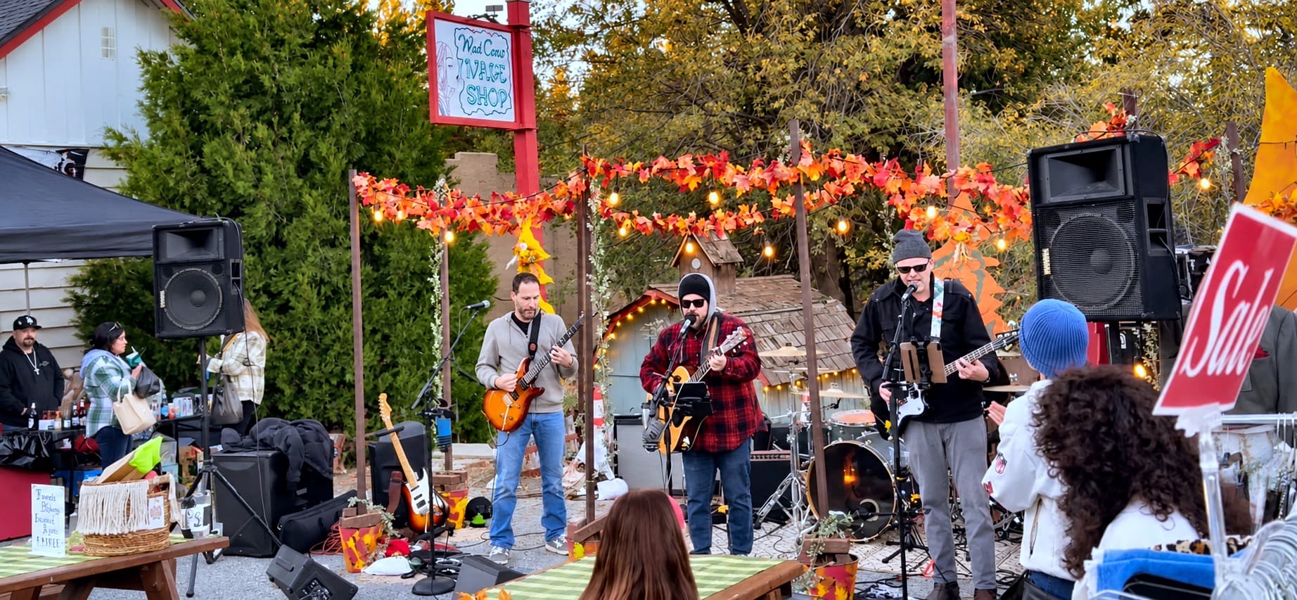 Live band performing on a decorated stage at a Running Springs community event