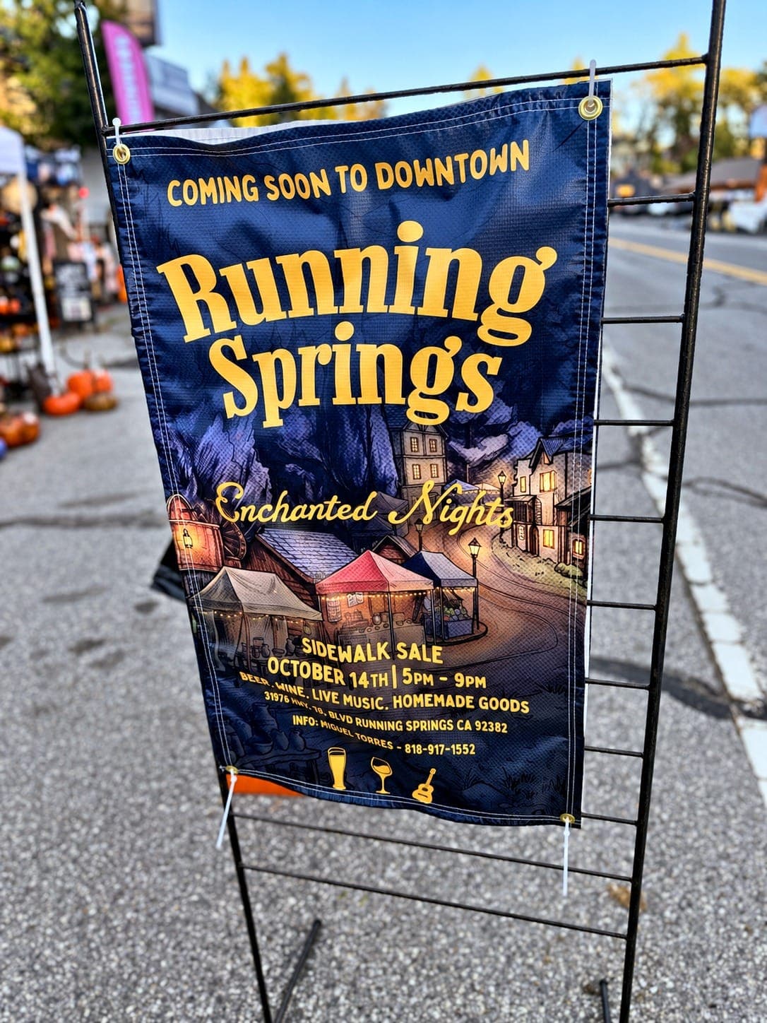 Running Springs Enchanted Nights event banner on a downtown street sign stand