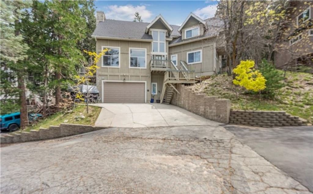 Front of 163 S Grass Valley with the garage, driveway, and stairs to the main entry in Lake Arrowhead