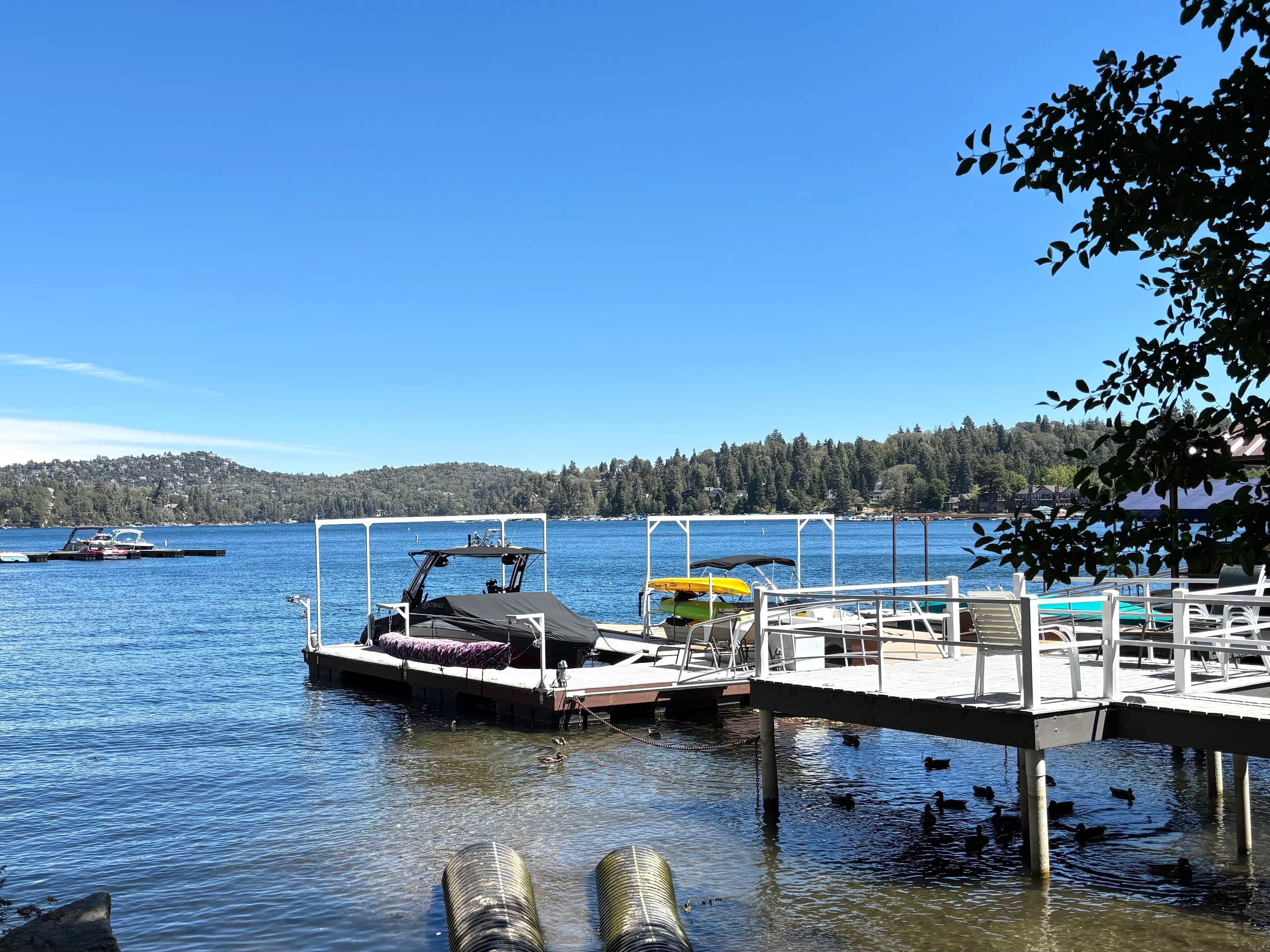 Private boat slips and a covered motorboat along the Lake Arrowhead shoreline
