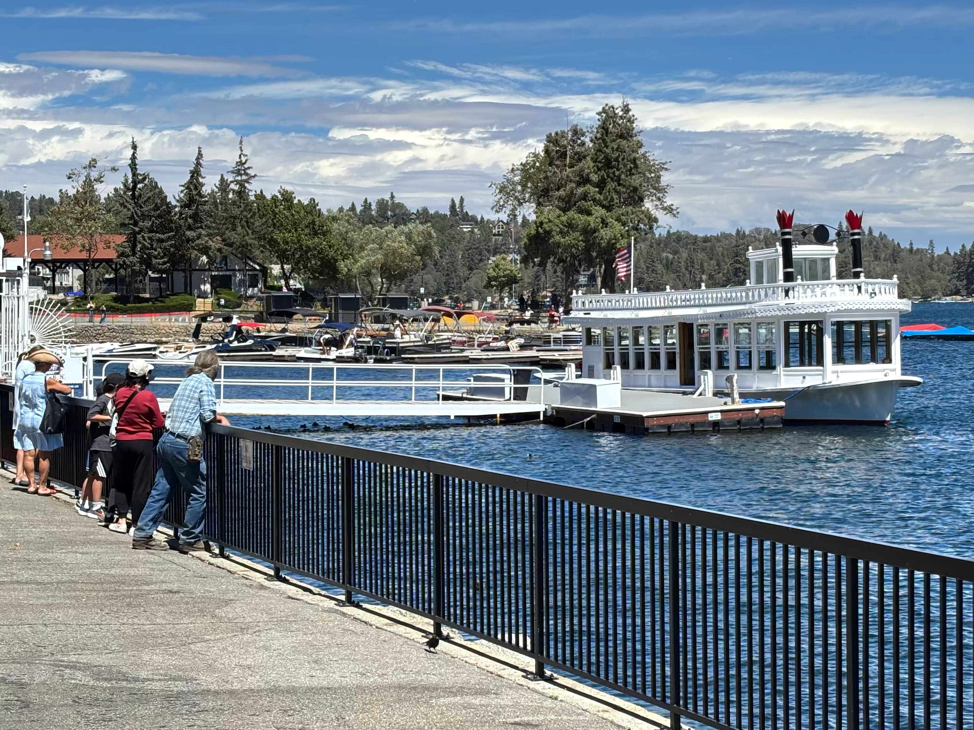 Lake Arrowhead Queen tour boat docked at Lake Arrowhead Village with visitors at the railing