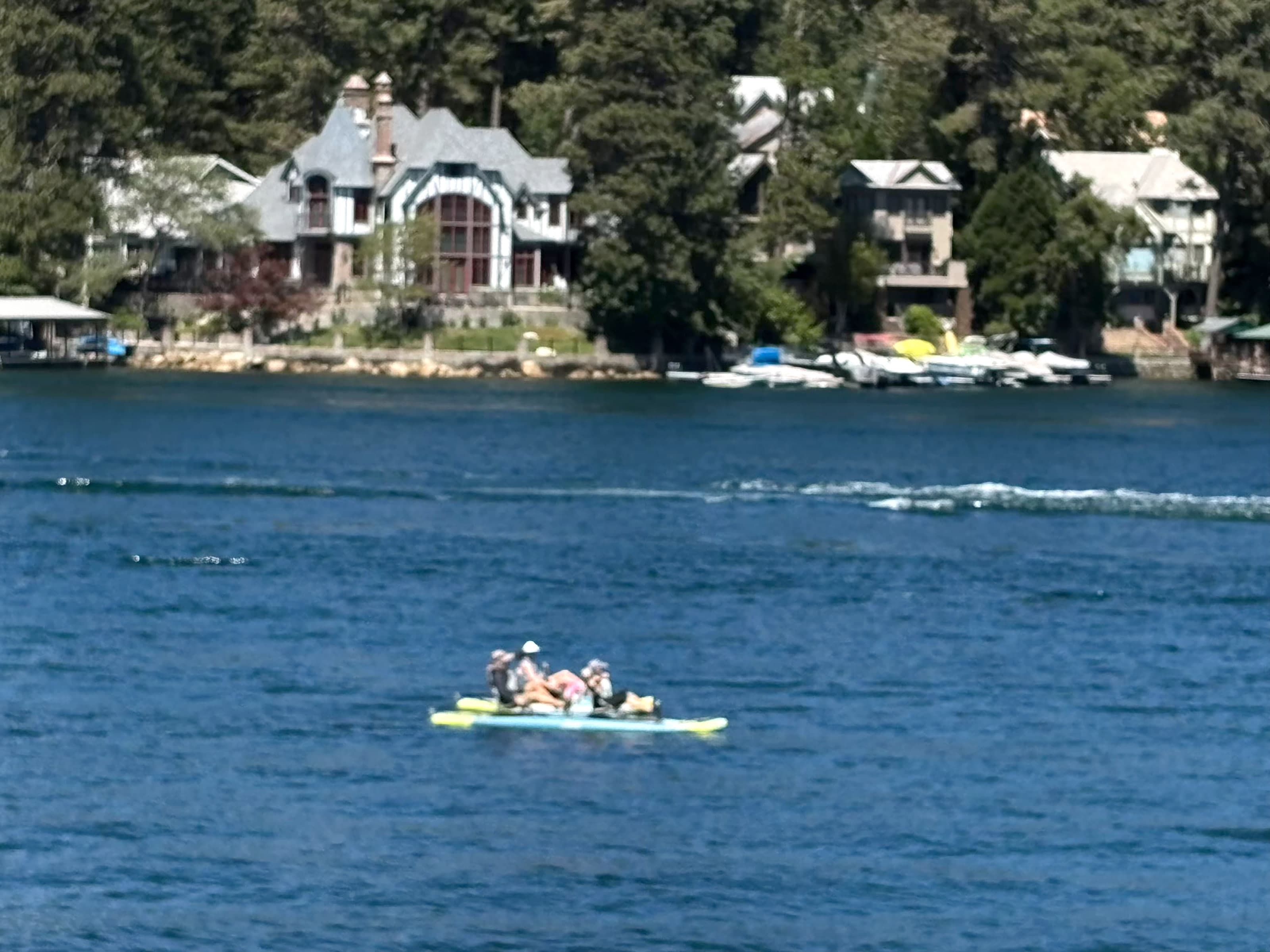 Recreation on Lake Arrowhead in front of Tudor-style lakefront houses.
