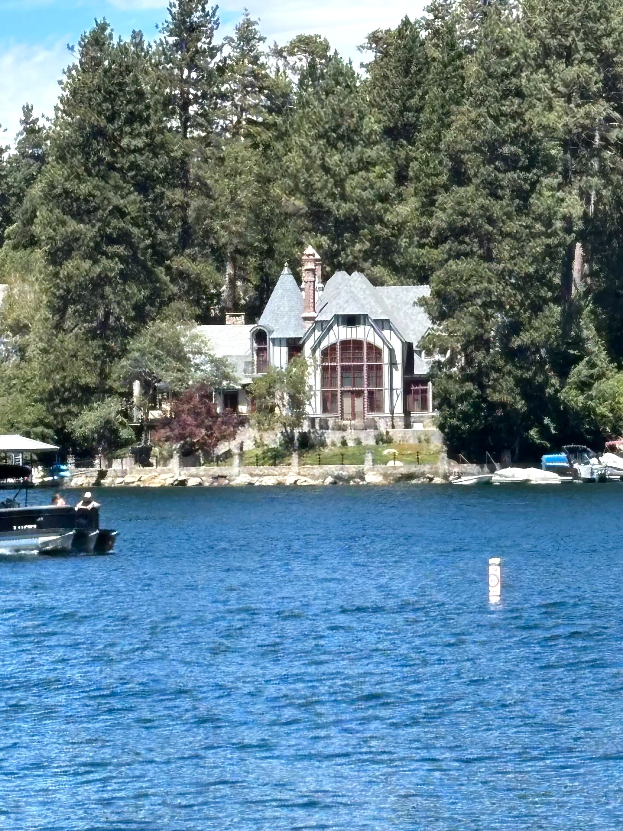 Tudor-style lakefront house behind a stone wall on Lake Arrowhead