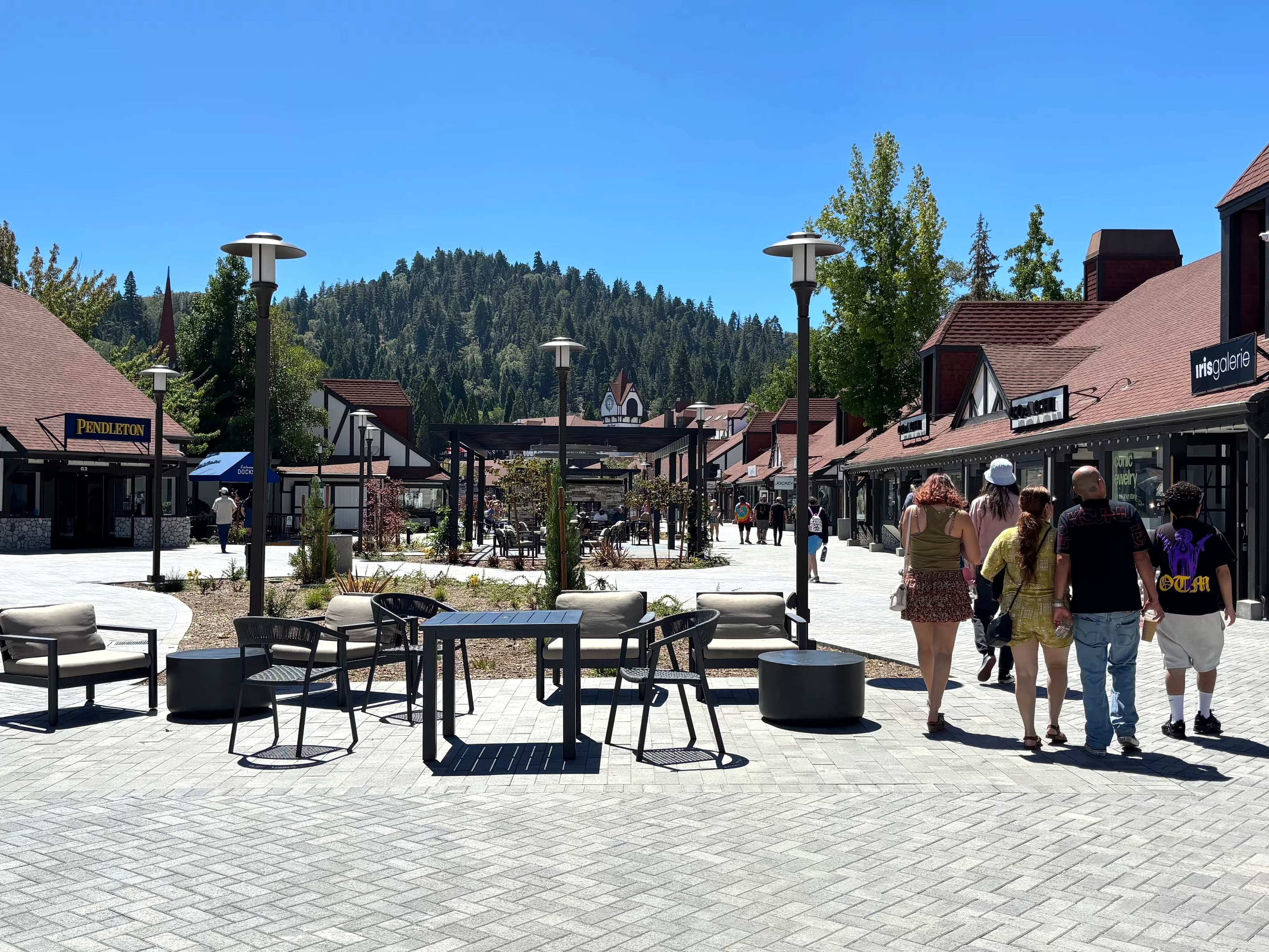 Lake Arrowhead Village courtyard shops with a forested mountain behind