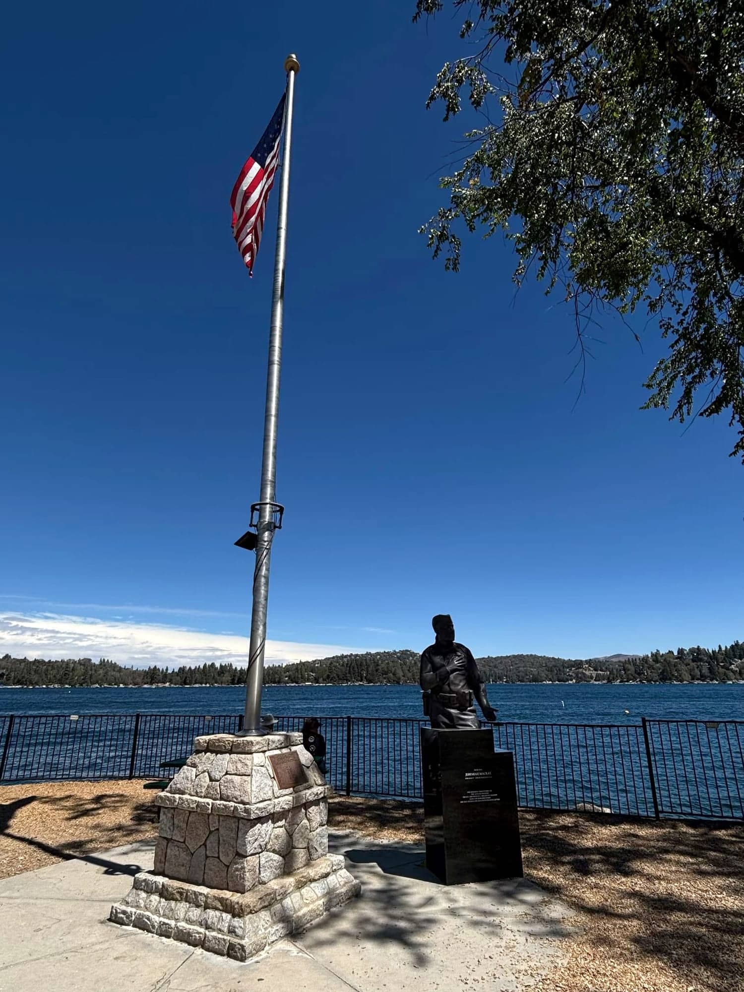 American flag on a stone base overlooking Lake Arrowhead from the Village waterfront