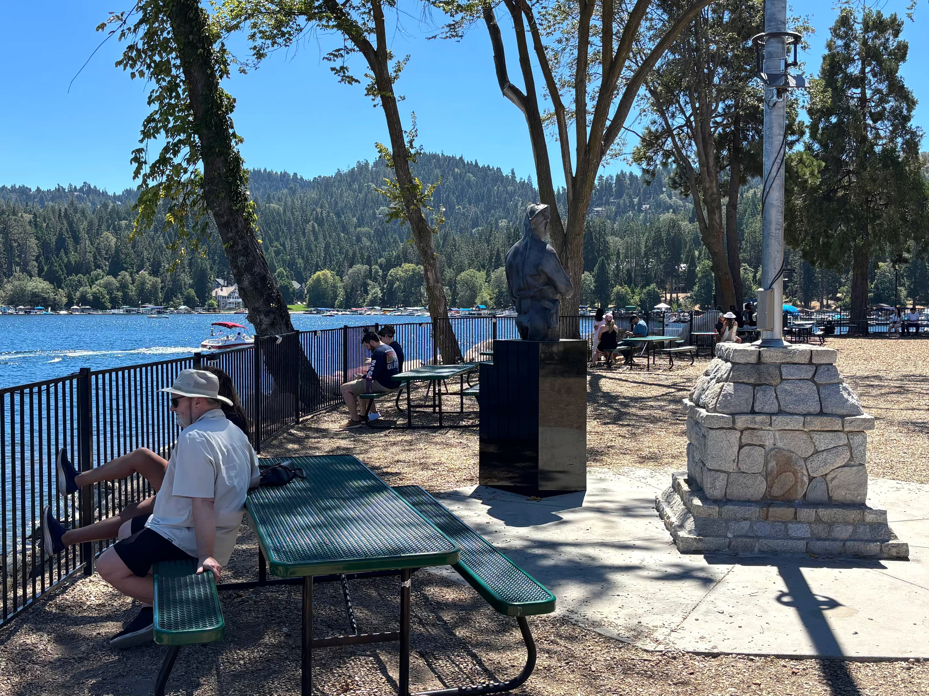 Lake Arrowhead Village park with picnic tables, memorial, and lake view