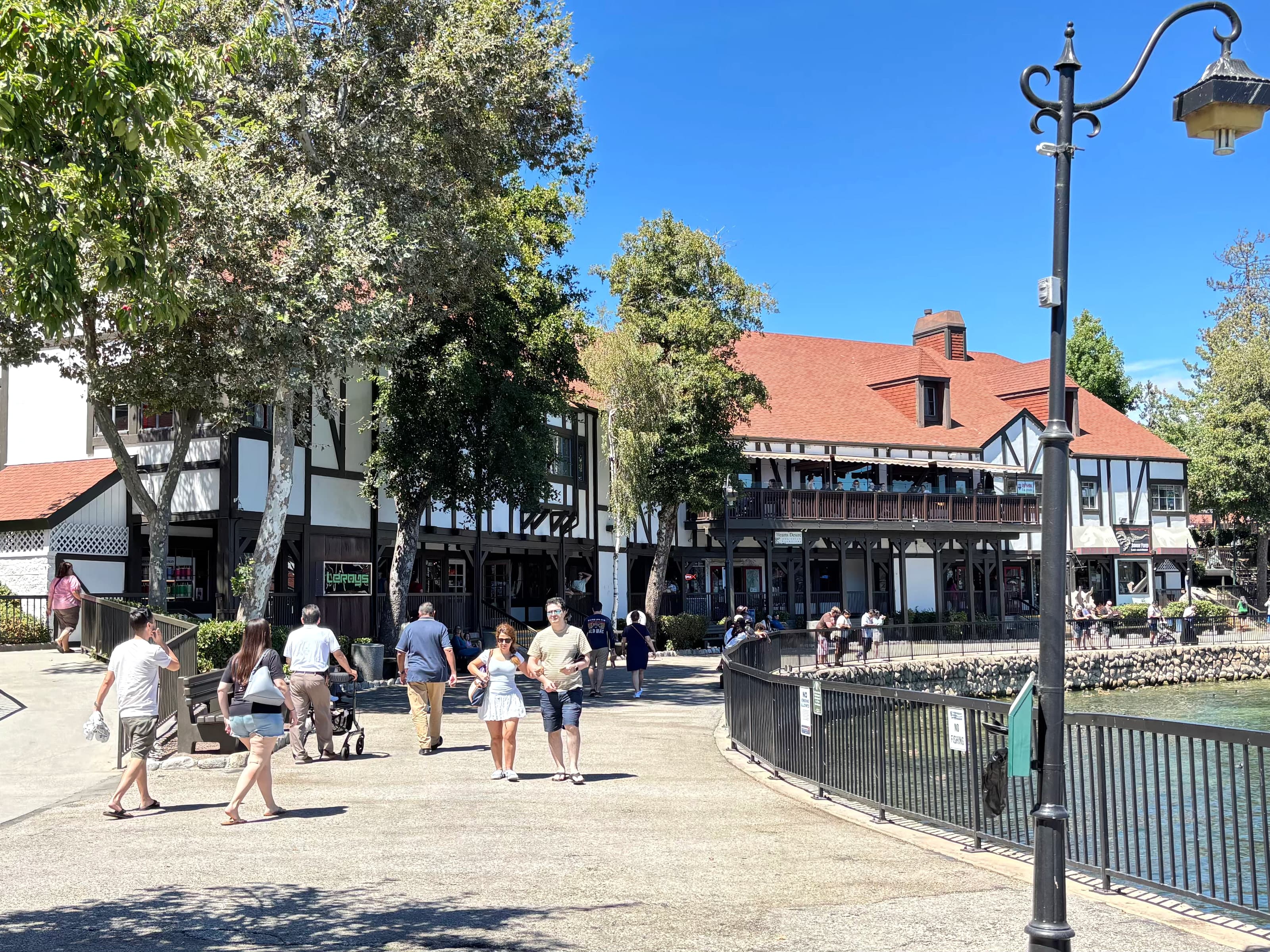 Waterfront promenade at Lake Arrowhead Village with Tudor shops and lake railing