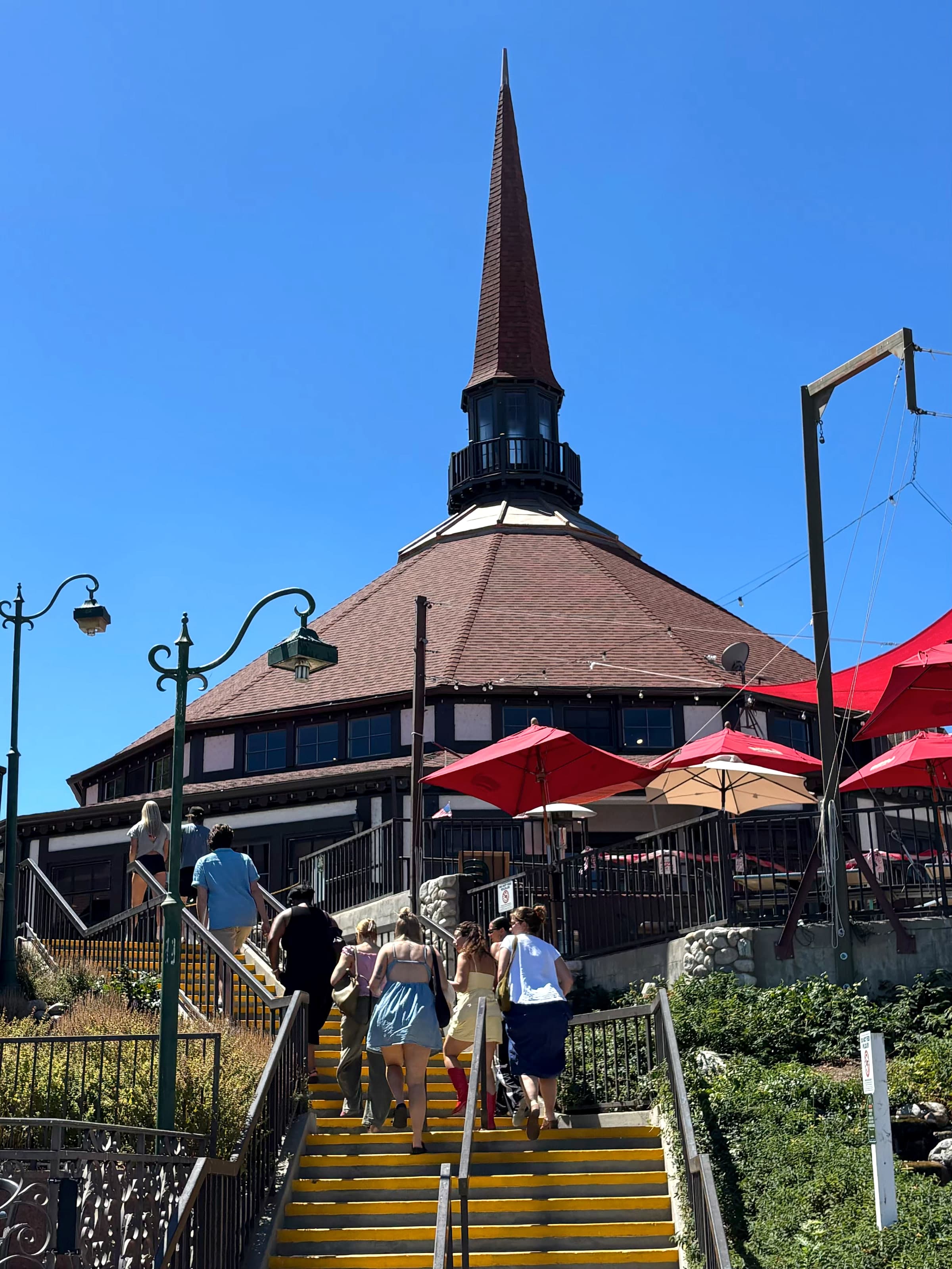 Lake Arrowhead Village landmark spire above stairs with yellow safety strips