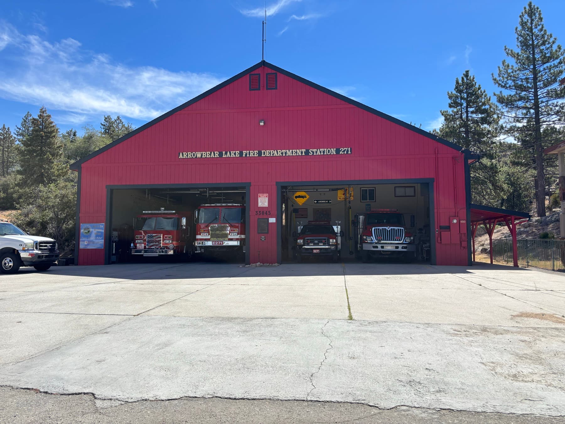 Arrowbear Lake Fire Department Station 271 building with apparatus bay and forest behind it