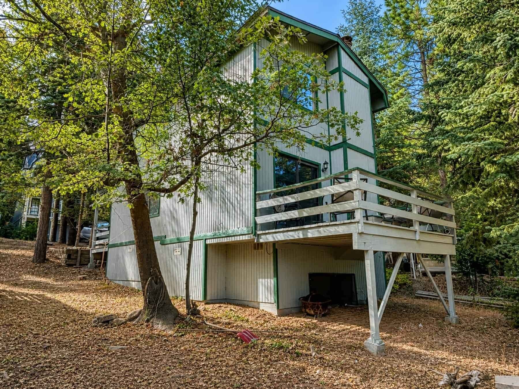 Mountain home with a light-colored deck among pines in Running Springs.
