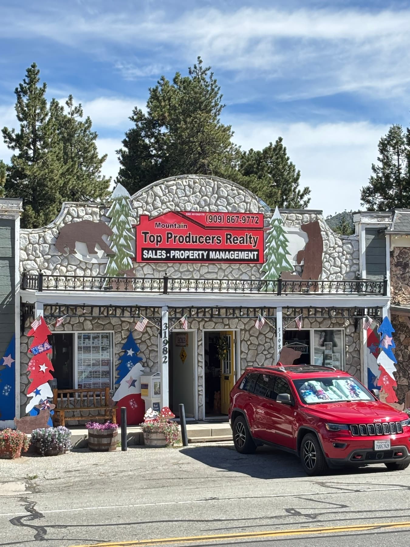 Mountain Top Producers Realty storefront with stone facade and bear cutouts in Running Springs