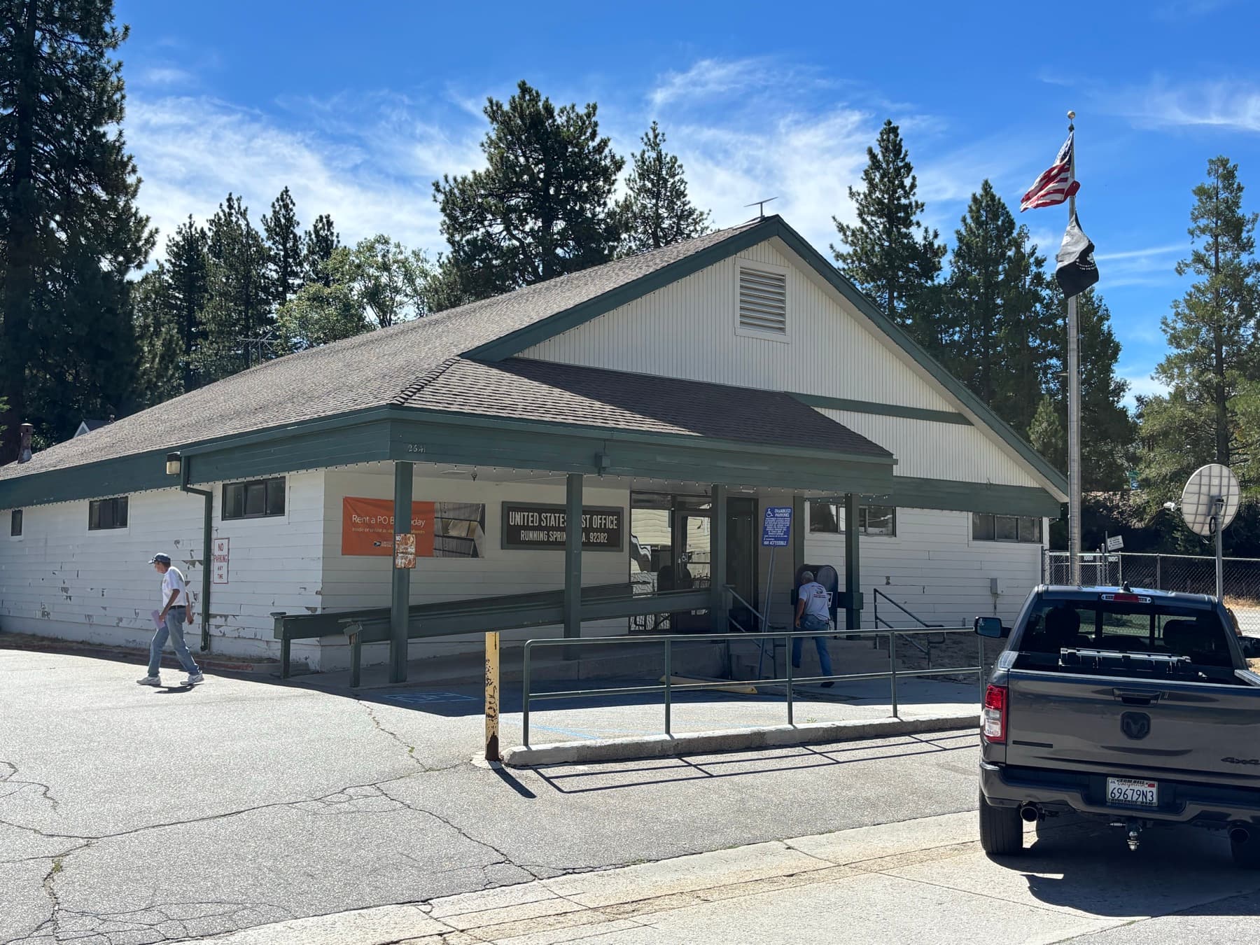 United States Post Office building in Running Springs with a ramp and pine trees