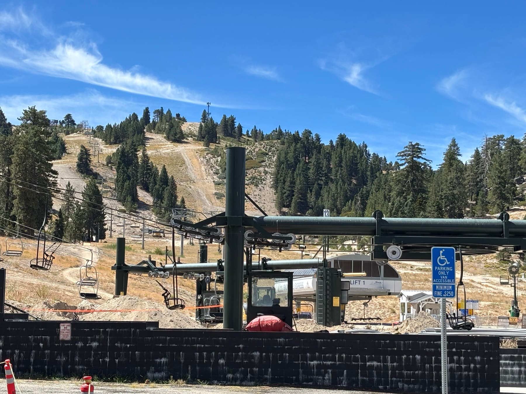 Snow Valley Lift 1 chairlift base on a dry forested slope in summer